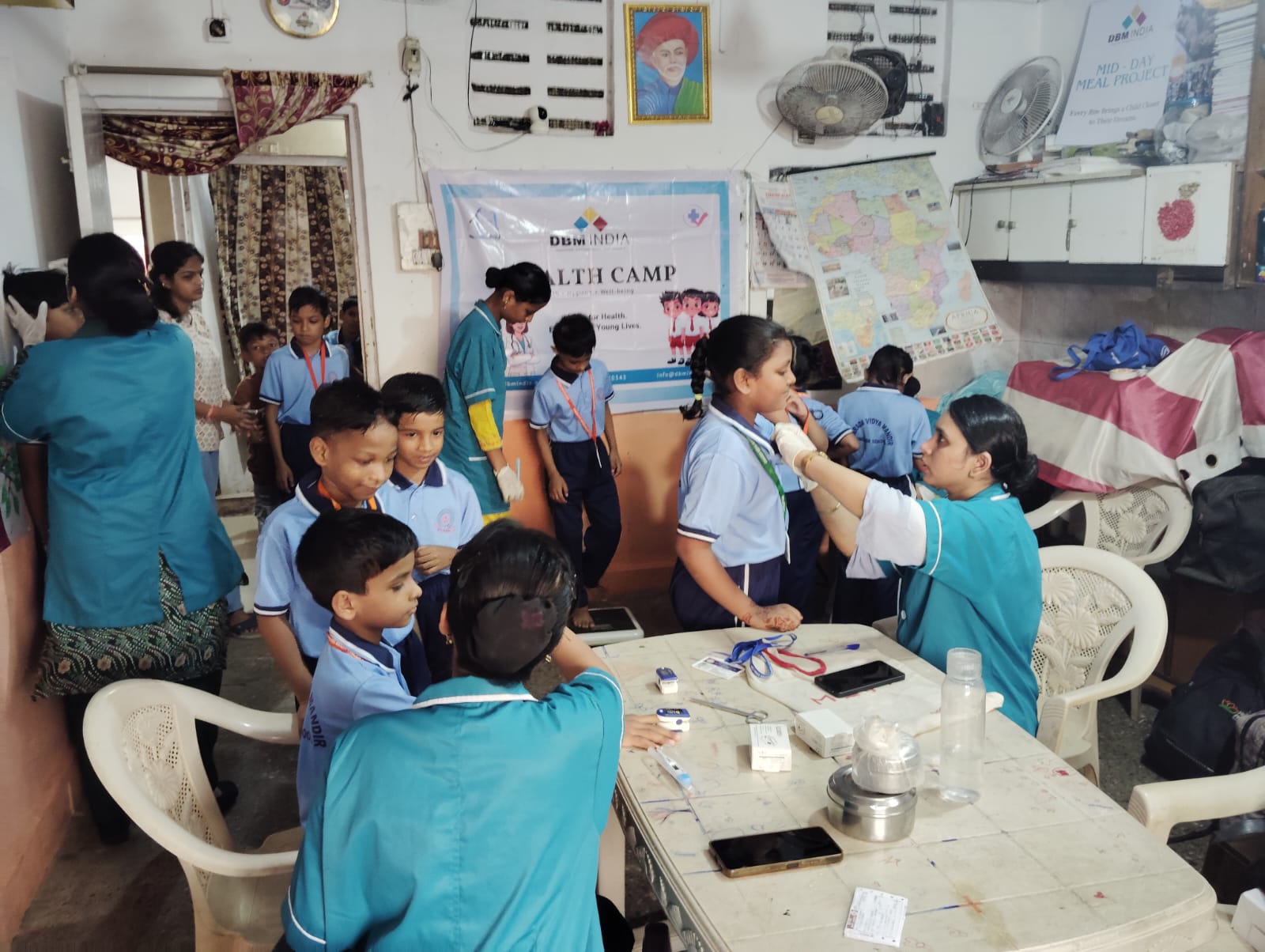 DBM India health camp — children being screened by medical staff